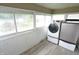 Bright laundry room with white walls and floor to ceiling windows overlooking the yard at 364 S Cole St, Indianapolis, IN 46241