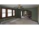 Inviting living room featuring original windows, carpet, and an archway leading to the rest of the home at 364 S Cole St, Indianapolis, IN 46241