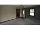 Cozy living room featuring original windows, carpet, and doorways leading to the rest of the home at 364 S Cole St, Indianapolis, IN 46241