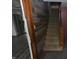 Staircase with wooden handrail, wood-look accent wall, and entryway at 364 S Cole St, Indianapolis, IN 46241