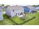 Spacious fenced backyard featuring a play set and patio at 3667 Gilmore Pl, Bargersville, IN 46106