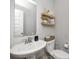 Stylish half bathroom featuring a pedestal sink, decorative shelves, and modern fixtures at 3667 Gilmore Pl, Bargersville, IN 46106
