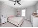 Light filled bedroom features a bed, nightstand and accent wall at 3667 Gilmore Pl, Bargersville, IN 46106