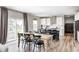 Modern kitchen with an island, stainless steel appliances, a dining table with chairs, and hardwood floors at 3667 Gilmore Pl, Bargersville, IN 46106