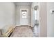 Inviting entryway with a white front door, a wood bench with a pillow, and an area rug on hardwood floors at 3667 Gilmore Pl, Bargersville, IN 46106