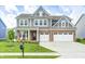 Beautiful two-story home featuring a brick facade, gray siding, a well-manicured lawn, and a two car garage at 3667 Gilmore Pl, Bargersville, IN 46106