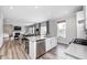 Open-concept kitchen and dining area with stainless steel appliances, island, and view into the living room at 3667 Gilmore Pl, Bargersville, IN 46106