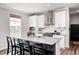 Bright kitchen showcasing stainless steel appliances, white cabinets, backsplash, and an island with barstool seating at 3667 Gilmore Pl, Bargersville, IN 46106
