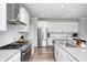 Modern kitchen featuring stainless steel appliances, white cabinets, subway tile backsplash, and quartz countertops at 3667 Gilmore Pl, Bargersville, IN 46106