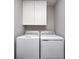 Functional laundry room features a stacked washer and dryer and white cabinets at 3667 Gilmore Pl, Bargersville, IN 46106