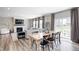 Open-concept living and dining area with fireplace, modern decor, and sliding glass doors to the backyard at 3667 Gilmore Pl, Bargersville, IN 46106