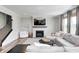 Comfortable living room featuring a fireplace, TV, large windows, and gray sectional sofa at 3667 Gilmore Pl, Bargersville, IN 46106