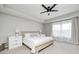 Serene main bedroom featuring a ceiling fan, tray ceiling, plush carpet, and soft, natural light at 3667 Gilmore Pl, Bargersville, IN 46106