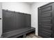 Convenient mudroom featuring a built-in bench with coat hooks and a dark paneled door at 3667 Gilmore Pl, Bargersville, IN 46106