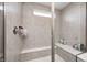 Walk in shower with gray tile surround, glass doors, built in bench and shampoo niche at 3667 Gilmore Pl, Bargersville, IN 46106