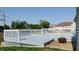 Two-tiered backyard deck with white railing and a fire pit for outdoor entertaining at 3959 Towhees Dr, Indianapolis, IN 46237