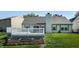 Well maintained backyard with a small grass area, garden, and white fenced deck at 3959 Towhees Dr, Indianapolis, IN 46237
