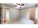 Well-maintained bedroom with neutral colored carpet, ceiling fan, and access to bathroom and closet at 3959 Towhees Dr, Indianapolis, IN 46237