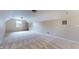 Spacious bonus room with neutral carpet and paint, featuring a window and built-in shelves at 3959 Towhees Dr, Indianapolis, IN 46237