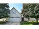 Charming two-story home with brick accents, a two-car garage, and a well-maintained front yard with mature trees at 3959 Towhees Dr, Indianapolis, IN 46237