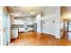 Bright kitchen features white cabinetry, granite countertops, stainless steel appliances, and hardwood flooring at 3959 Towhees Dr, Indianapolis, IN 46237