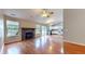 Bright living room featuring hardwood floors, a fireplace, and large windows offering plenty of natural light at 3959 Towhees Dr, Indianapolis, IN 46237