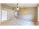 Spacious main bedroom with neutral tones, a ceiling fan, and a view into the main bathroom at 3959 Towhees Dr, Indianapolis, IN 46237