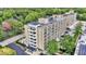 Aerial view of an apartment complex surrounded by lush greenery and a parking area at 3965 N Meridian St # 3J West, Indianapolis, IN 46208