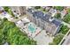 Aerial view showcasing a multi-story building with a swimming pool and parking; many mature trees surround the property at 3965 N Meridian St # 3J West, Indianapolis, IN 46208