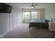 Carpeted bedroom featuring a closet with folding doors and a large window letting in natural light at 3965 N Meridian St # 3J West, Indianapolis, IN 46208