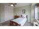 Bedroom featuring carpet floors, a ceiling fan, a closet with folding doors, and a wooden bed frame at 3965 N Meridian St # 3J West, Indianapolis, IN 46208