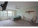 Cozy bedroom with a ceiling fan, a rocking chair, carpet floors, and a window view at 3965 N Meridian St # 3J West, Indianapolis, IN 46208