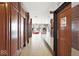 Hallway with wood paneled walls and a mirrored wall with the view of the lobby area at 3965 N Meridian St # 3J West, Indianapolis, IN 46208