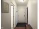 Well-lit hallway leading to the main living areas with neutral wall paint at 3965 N Meridian St # 3J West, Indianapolis, IN 46208