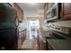 Galley kitchen with stainless steel appliances and hardwood floors at 3965 N Meridian St # 3J West, Indianapolis, IN 46208