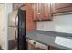 Close-up of kitchen area featuring appliances, countertops, wooden cabinetry, and dishwasher at 3965 N Meridian St # 3J West, Indianapolis, IN 46208