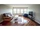 Cozy living room with hardwood floors and a large window at 3965 N Meridian St # 3J West, Indianapolis, IN 46208