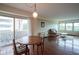 Living area with hardwood floors, dining table, and sliding doors to a balcony at 3965 N Meridian St # 3J West, Indianapolis, IN 46208