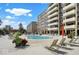 Outdoor pool with deck chairs at an apartment complex under a sunny, blue sky at 3965 N Meridian St # 3J West, Indianapolis, IN 46208