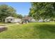 A beautifully landscaped backyard features a fire pit, patio, and lush lawn, perfect for outdoor living at 4195 Locust Ln, Brownsburg, IN 46112