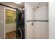 A convenient stacked washer and dryer in the bathroom next to a shower with white tile at 4195 Locust Ln, Brownsburg, IN 46112