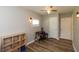 Bedroom with a ceiling fan, wood-look floors, and a study area with a modern desk at 4195 Locust Ln, Brownsburg, IN 46112
