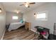 Bedroom features a ceiling fan, wood-look flooring, and natural lighting from windows at 4195 Locust Ln, Brownsburg, IN 46112