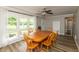 Bright dining room features wood floors, a ceiling fan, and large windows offering ample natural light at 4195 Locust Ln, Brownsburg, IN 46112
