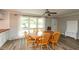 Bright dining room features wood floors, a ceiling fan, and large windows offering ample natural light at 4195 Locust Ln, Brownsburg, IN 46112