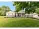 Charming single-story home with stone accents, covered porch, and well-manicured front lawn and a detached garage at 4195 Locust Ln, Brownsburg, IN 46112
