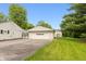 Property featuring a detached garage and private driveway, set against a backdrop of green grass at 4195 Locust Ln, Brownsburg, IN 46112