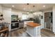 Bright kitchen boasts stainless steel appliances, white cabinets, and a center island with a wooden countertop at 4195 Locust Ln, Brownsburg, IN 46112
