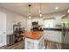 Spacious kitchen with white cabinets, stainless steel appliances, and a center island with a wooden countertop at 4195 Locust Ln, Brownsburg, IN 46112