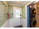 Mudroom featuring a laundry, tiled floor, and a door to the outdoor area at 4195 Locust Ln, Brownsburg, IN 46112